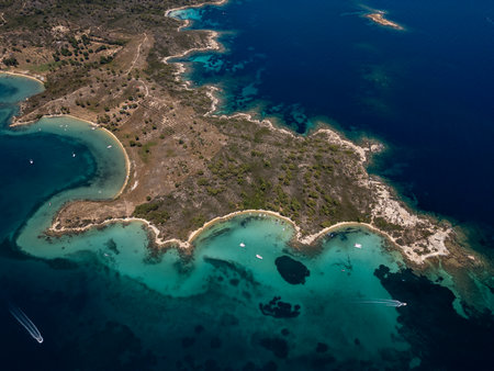 Aerial view of a scenic Mediterranean peninsula with turquoise water, boats, and small beaches. Beautiful summer seascape ideal for travel, tourism, and nature-related projectsの写真素材
