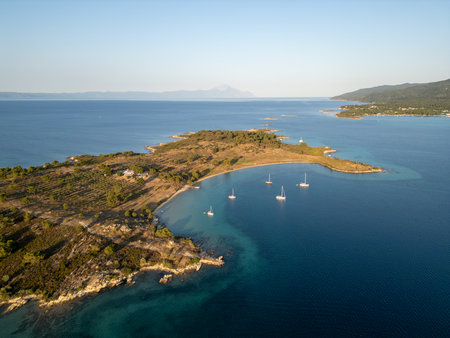 Aerial view of a scenic Mediterranean peninsula with turquoise water, boats, and small beaches. Beautiful summer seascape ideal for travel, tourism, and nature-related projectsの写真素材
