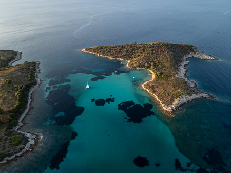 Aerial view of a scenic Mediterranean peninsula with turquoise water, boats, and small beaches. Beautiful summer seascape ideal for travel, tourism, and nature-related projectsの写真素材