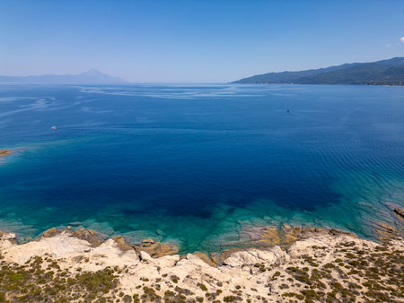 Aerial view of a scenic Mediterranean peninsula with turquoise water, boats, and small beaches. Beautiful summer seascape ideal for travel, tourism, and nature-related projectsの写真素材
