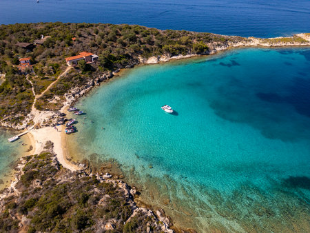 Aerial view of a scenic Mediterranean peninsula with turquoise water, boats, and small beaches. Beautiful summer seascape ideal for travel, tourism, and nature-related projectsの写真素材