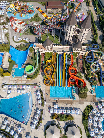 Top-down aerial view of a colorful water park in Nessebar, Bulgaria, with pools and slides. Vibrant summer resort scene showing leisure, recreation and tourism from a drone perspectiveの写真素材