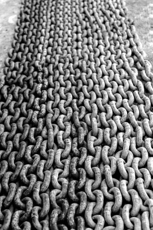 Old chain on the floor back and white
