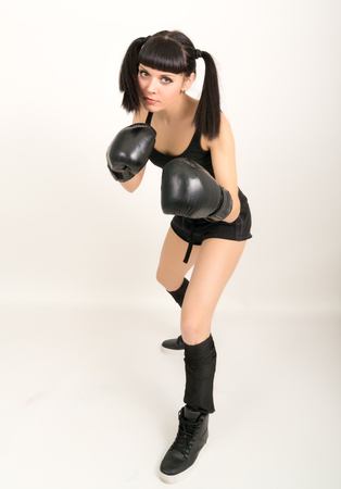female boxer - fitness woman boxing wearing boxing black glovesの写真素材