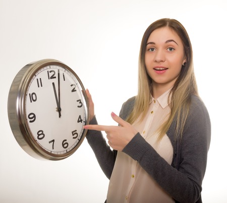 Surprise young woman looking at alarm clock with blank copy space, closeup portrait of beautiful europian woman, positive human emotion facial expressionの写真素材