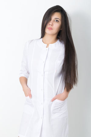 beautiful young asian female doctor in medical gown holding  phonendoscope.の写真素材