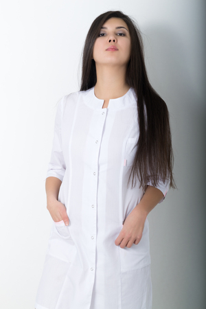 beautiful young asian female doctor in medical gown holding  phonendoscope.の写真素材