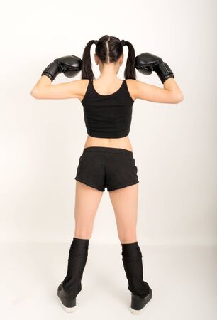 female boxer - fitness woman boxing wearing boxing black glovesの写真素材