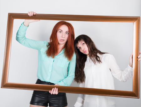 two girls girlfriend got into the frame of the picture, optimistic lady having solution and bored,...