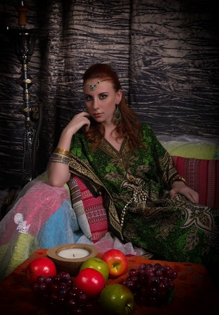 Closeup of Beautiful caucasian woman dressed in oriental style with oriental patterns on the hands...