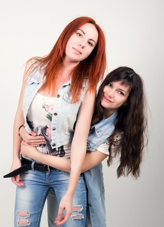 two girlfriends were offended, turned their backs to each other. different emotions. looking away after conflict at home.の写真素材