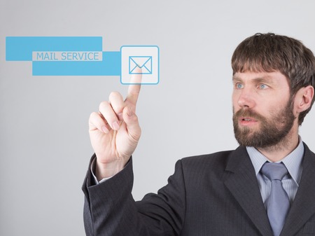 technology, internet and networking concept - Businessman presses mail service button on virtual...