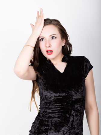 funny casual woman slaps his forehead in an oh-no moment, disappointed. different happy emotions.の写真素材