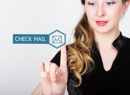technology, internet and networking concept. beautiful woman in a black business shirt. woman presses check mail button on virtual screens.の写真素材