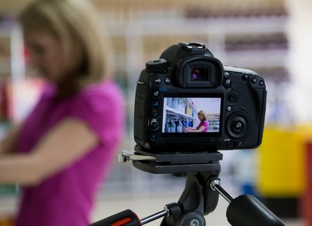 close-up camera on his screen girl chooses engine oil in auto parts store.の写真素材