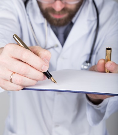close-up hands and pen, the doctor signs a handle documents. Doctor writes medical history. write a prescription patient data history.の写真素材