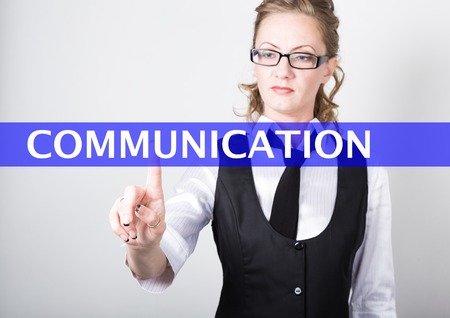 communication written on a virtual screen. Internet technologies in business and tourism. woman in business suit and tie, presses a finger on a virtual screen.の写真素材