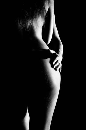 Close-Up Beautiful sexy young couple, naked man and woman. only visible contour of the body on a black background.の写真素材
