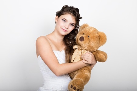 close-up portrait of curly girl holding a teddy bear.の写真素材