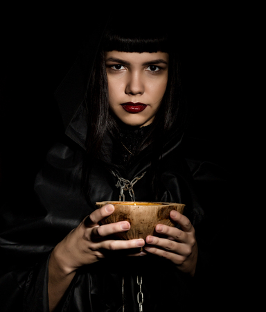 beautiful young witch with a book of spells.の写真素材