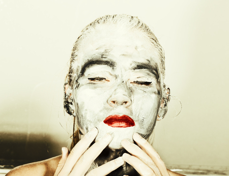 abstract art makeup. Face and neck girls smeared with gray colors and bright red lips. Holi Festival.の写真素材