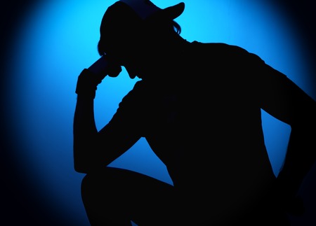 silhouette Rocker man posing on blue background.の写真素材