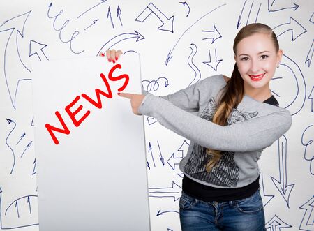 Young woman holding whiteboard with writing word: news. Technology, internet, business and marketing.の写真素材
