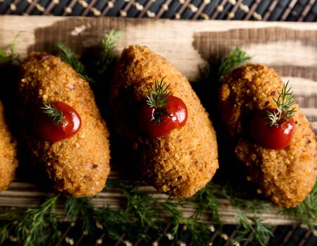 Homemade meat cutlets with parsley and ketchup on wooden plateの写真素材