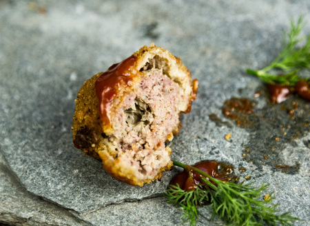 Homemade meat cutlets with parsley, ketchup and bread on white plateの写真素材