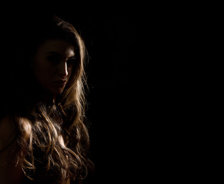 Woman Sexy Silhouette. Body scape of woman neck and hand on a dark background. free space for textの写真素材