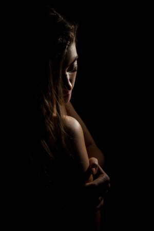 woman body contour on a dark background. female face and neck scapeの写真素材