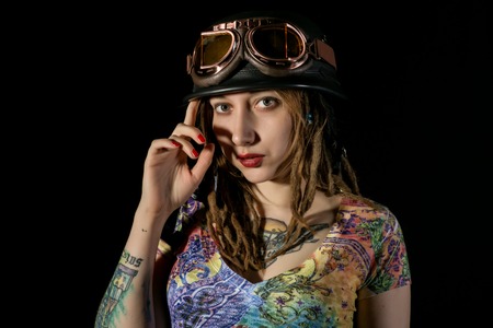 Female gothic warrior in pilot old glasses posing with katana swordの写真素材