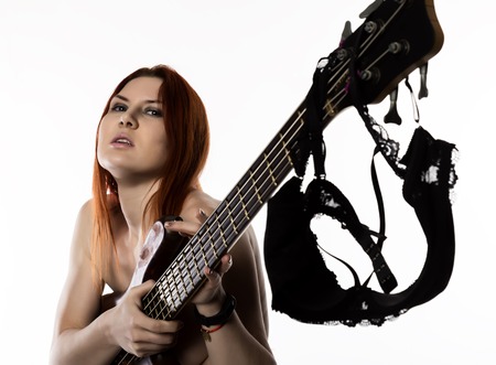 sexy nude rock woman playing on electric guitar on a white background.の写真素材