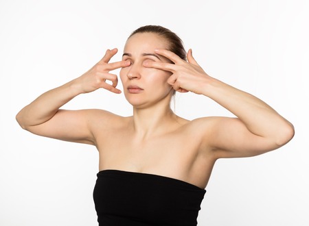woman doing face fitness, aging chang in the muscles of the face. beauty and health conceptの写真素材