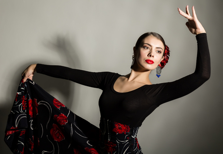 spanish girl flamenco dancer on a gray backgroundの写真素材