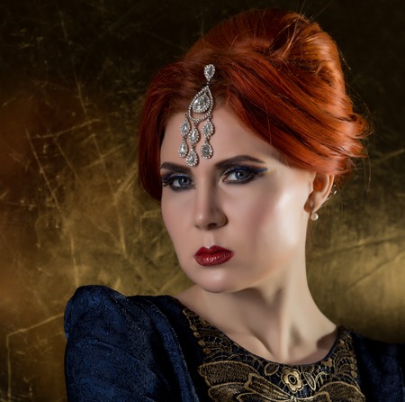 retro portrait of a beautiful woman on a dark background. attractive girl in vintage styleの写真素材