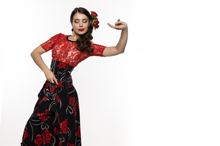 spanish girl flamenco dancer on a light background. free space for your textの写真素材