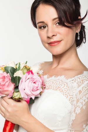 elegant bride with beautiful wedding bouquet in a hands. wedding make-up and hairstyle conceptの写真素材