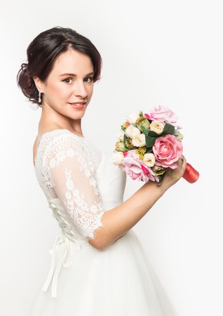 elegant bride with beautiful wedding bouquet in a hands. wedding make-up and hairstyle conceptの写真素材