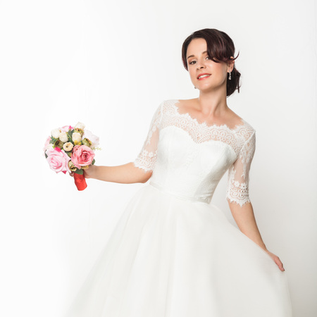 elegant bride with beautiful wedding bouquet in a hands. wedding make-up and hairstyle conceptの写真素材