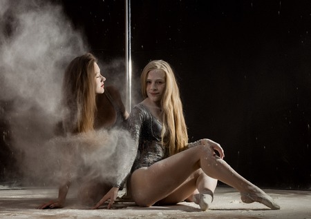 Two beautiful expressive dencer dancing at studio with flour on a body and sexy assの写真素材