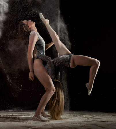 Two sexy striptease dencer dancing at night club with flour on a body and sexy assの写真素材