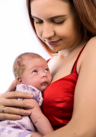 pretty woman kisses and hugging a newbornの写真素材