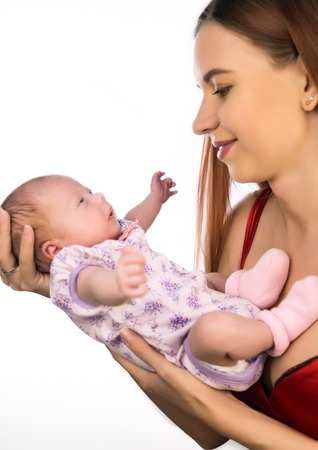 pretty woman kisses and hugging a newbornの写真素材