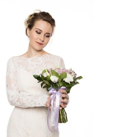 Beautiful bride with wedding bouquet in her hands. free space for your textの写真素材
