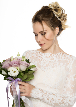 Beautiful bride with wedding bouquet in her handsの写真素材