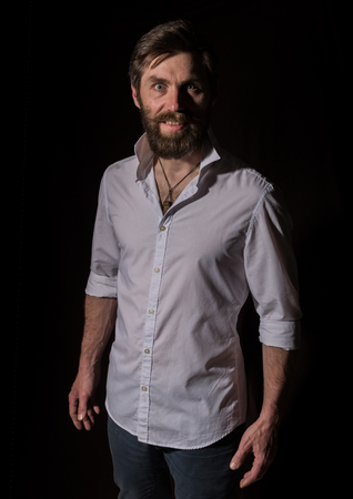 Portrait handsome bearded man, sexy guy on a dark backgroundの写真素材