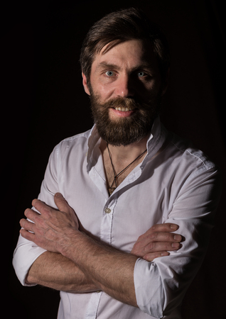 Portrait handsome bearded man, sexy guy on a dark backgroundの写真素材