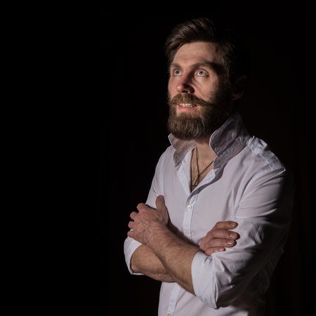 Portrait handsome bearded man, sexy guy on a dark backgroundの写真素材