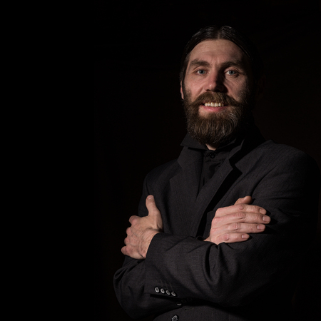 vintage handsome bearded man. severe man on a dark background. free space for your textの写真素材